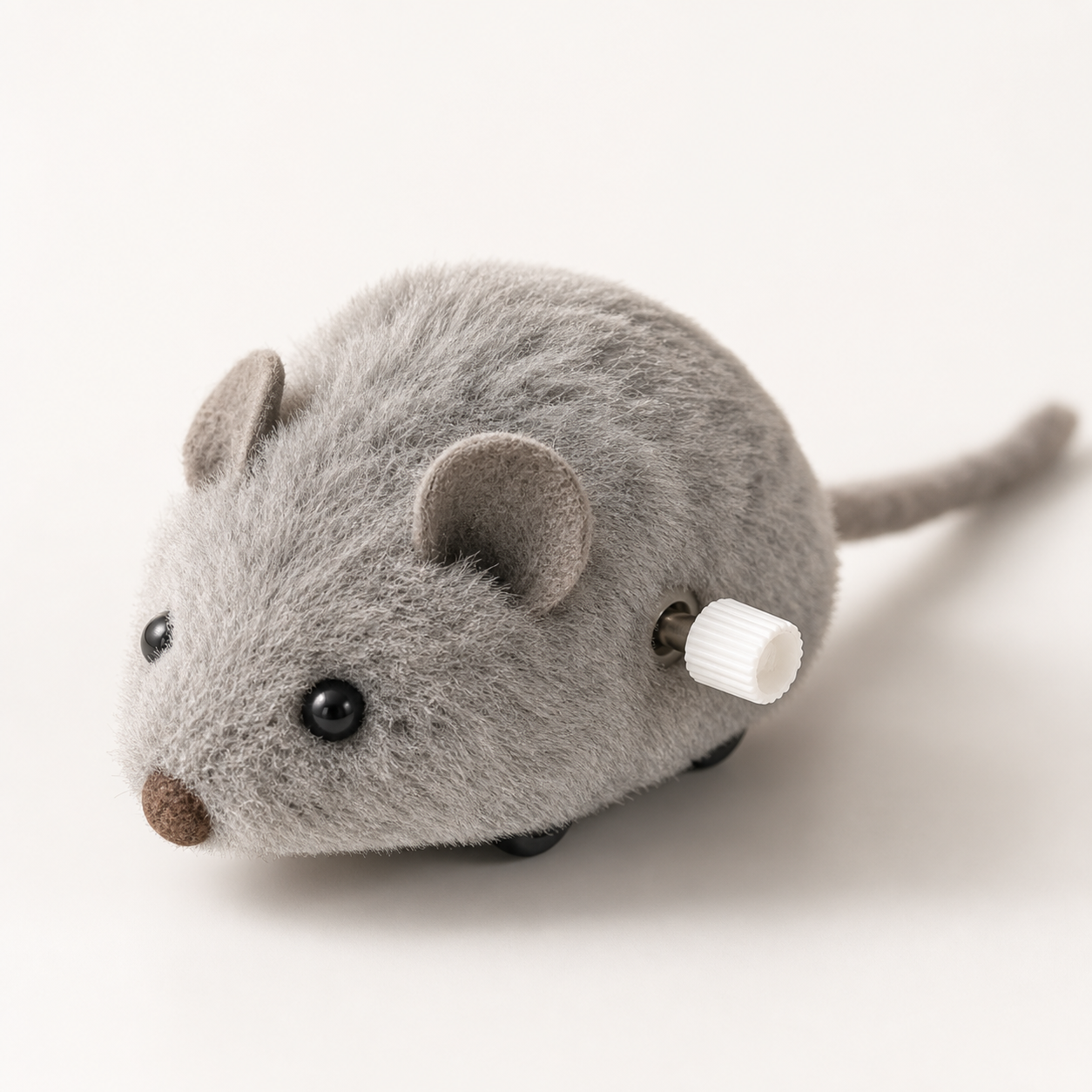 Close-up of the plush texture and wind-up mechanism on a mouse cat toy